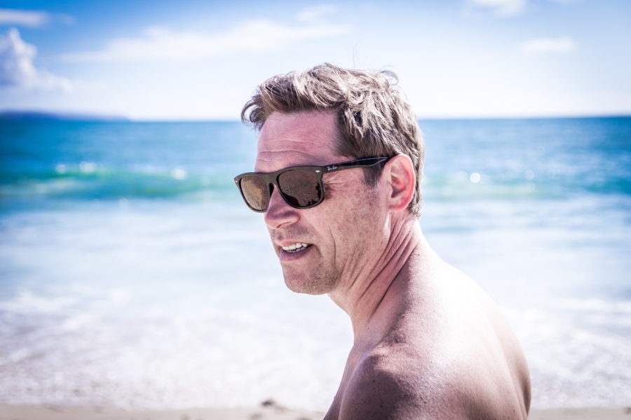 Middle-aged man at the beach who is managing his cholesterol with policosanol.