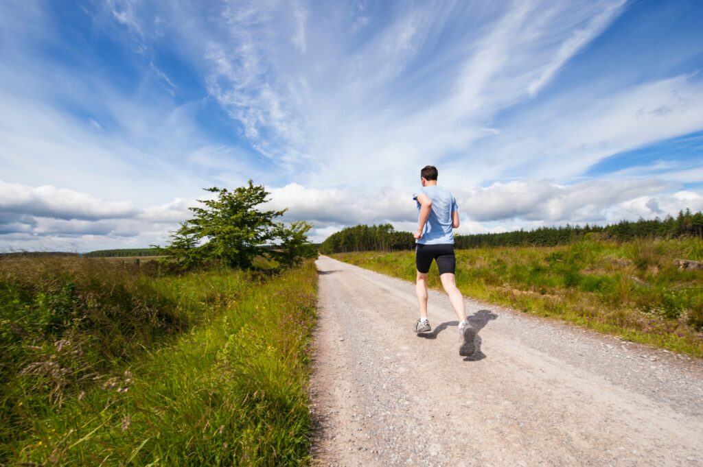 Man jogging on a trail as part of his regime to avoid statins.