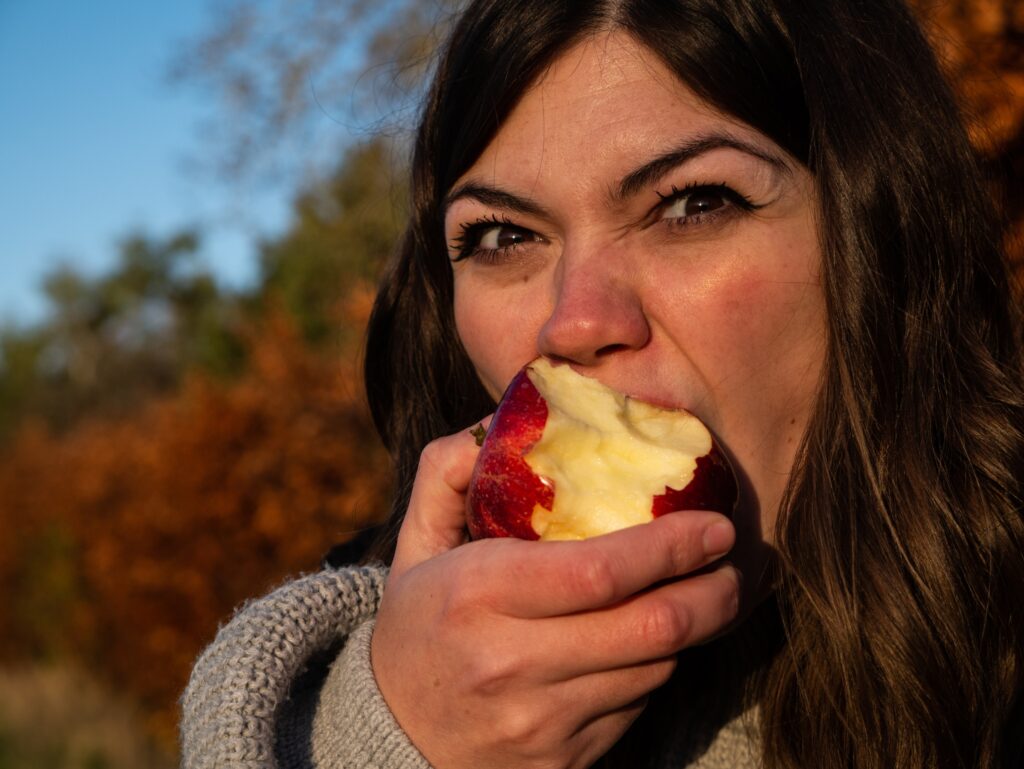 Woman eating an apple.