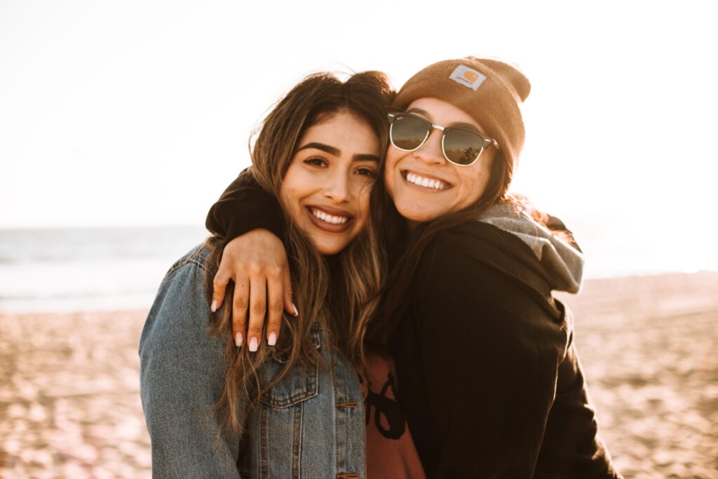 Two women laughing and hugging.