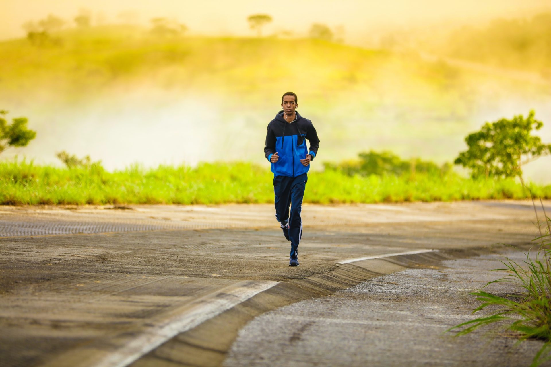 Man jogging on a road in the countryside.