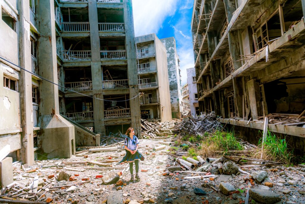 Child walking through war-torn buildings.