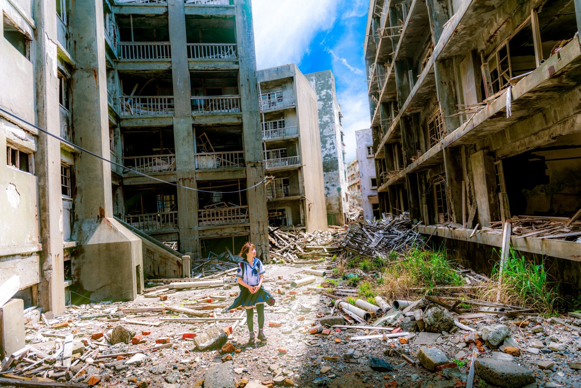 Child walking through war-torn buildings.