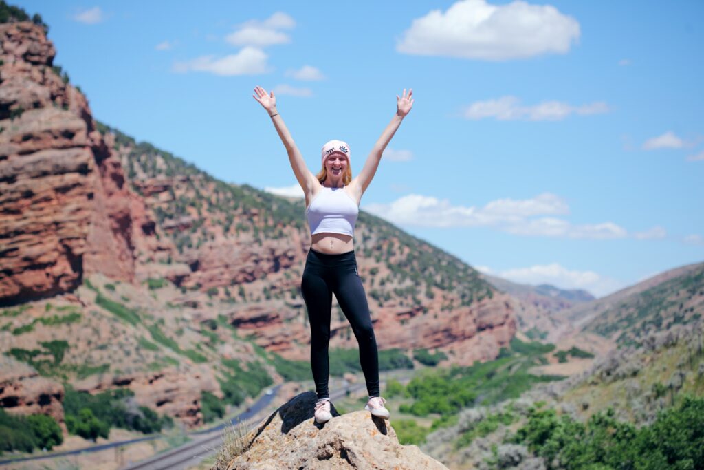 Healthy woman standing on top of a rock in Echo, Utah.