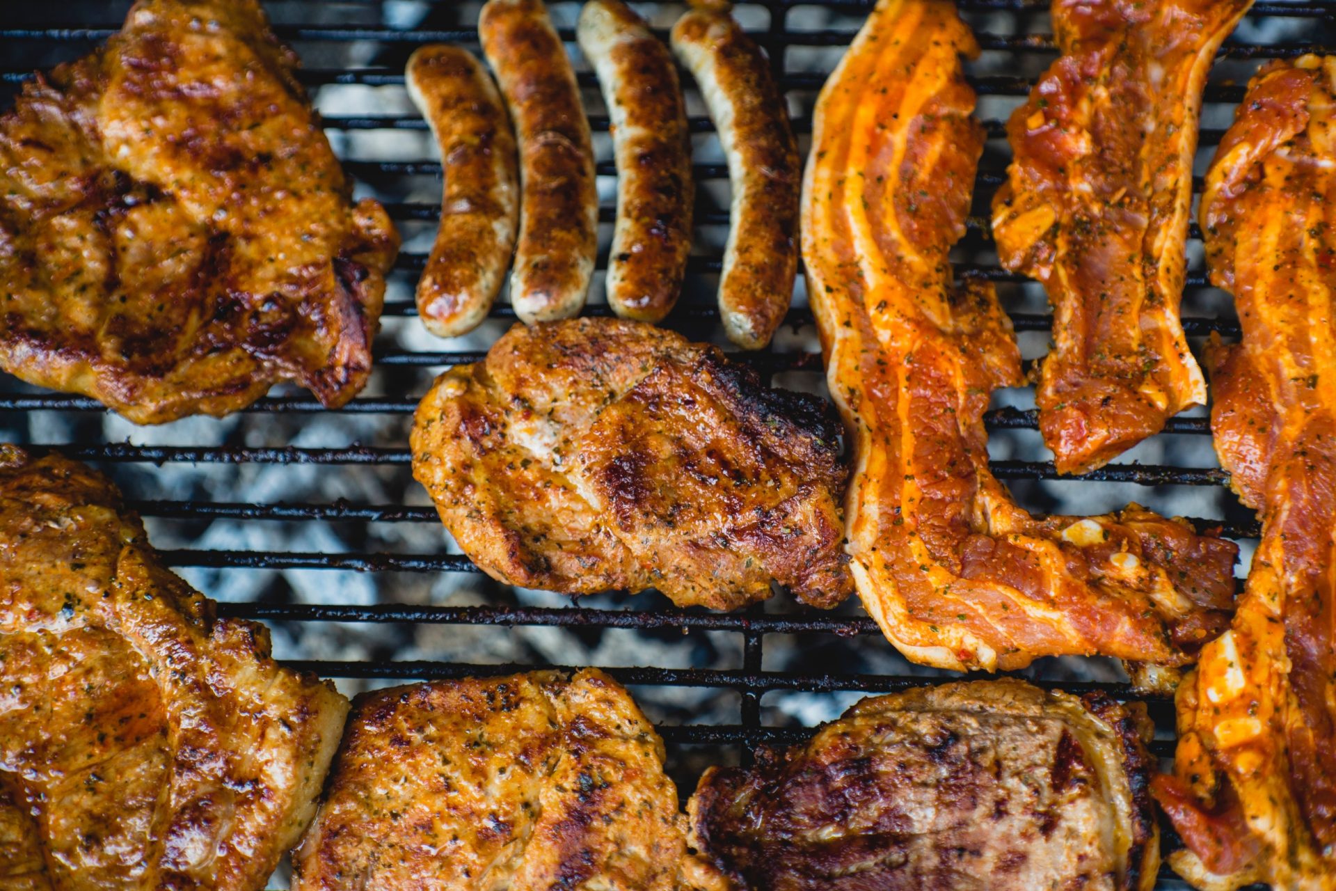 A variety of meats on a grill.