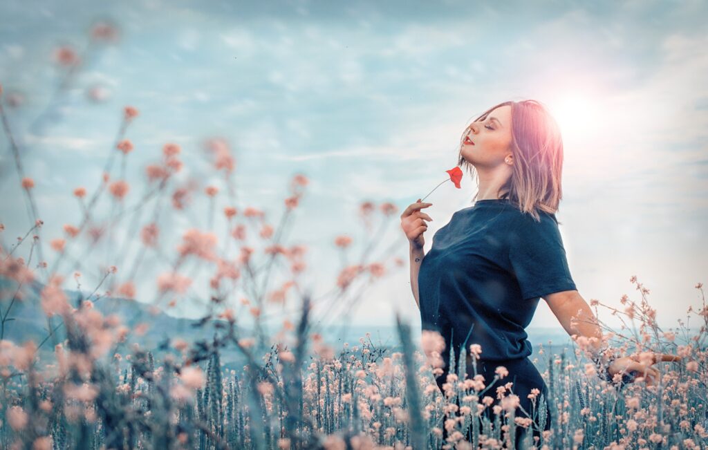 Woman in a field of flowers enjoying a moment in the sun.