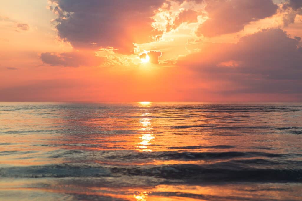Sunset over a calm ocean.