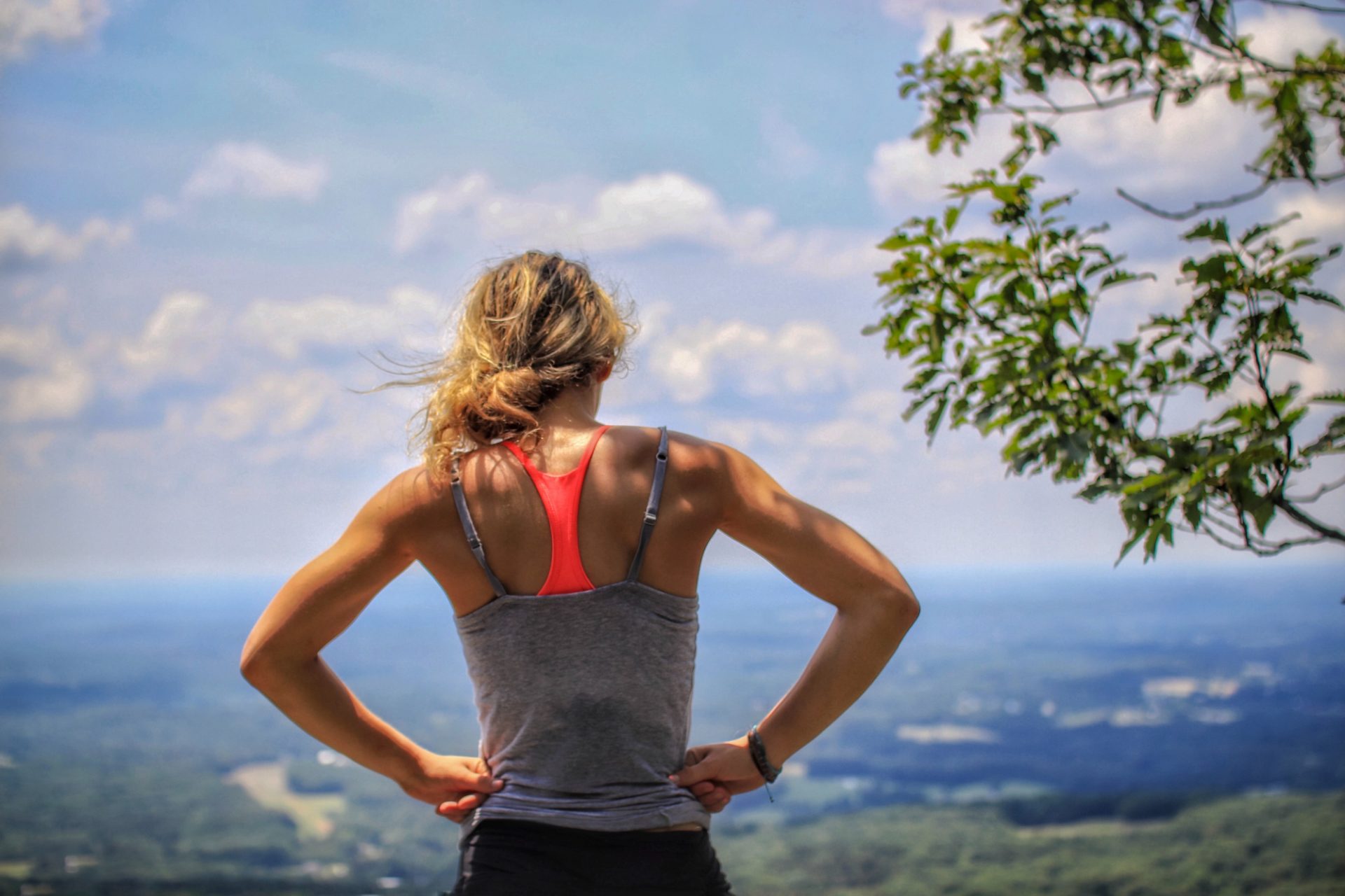 Fit woman looking out over a valley.
