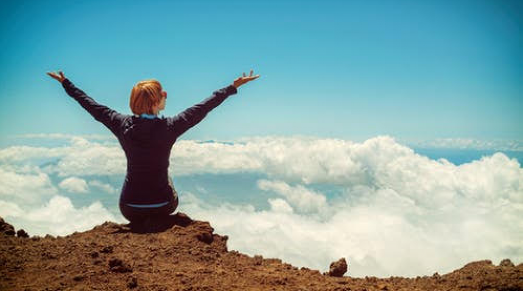 Women sitting on rock celebrating the effectiveness of her alternative therapy for depression