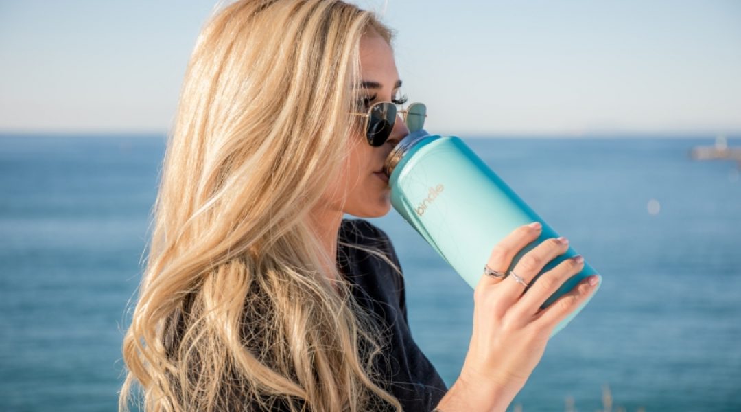 Woman drinking water with glutamine powder dissolved in it.