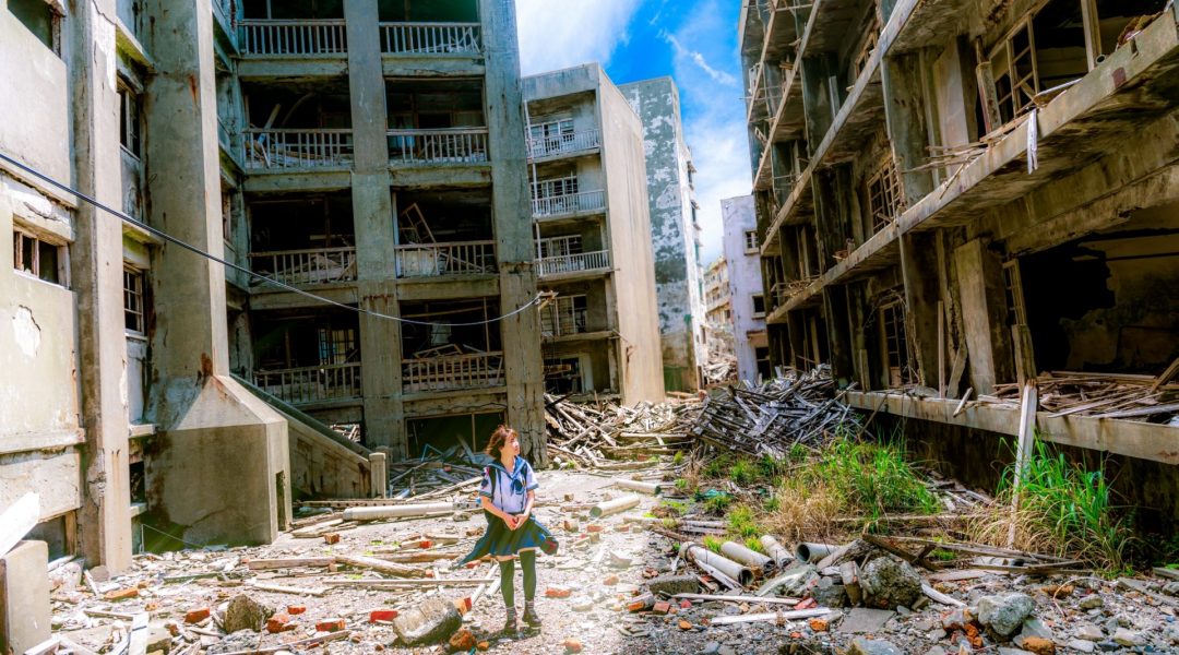 Child walking through war-torn buildings.