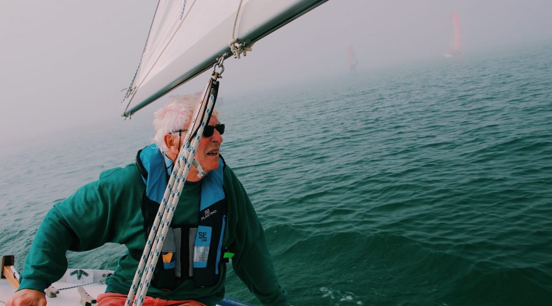 Older man sailing and enjoying his longer life because of the simple lifestyle changes he made years ago.