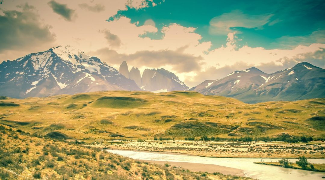 Beautiful landscape picture of mountains, hills and a stream.
