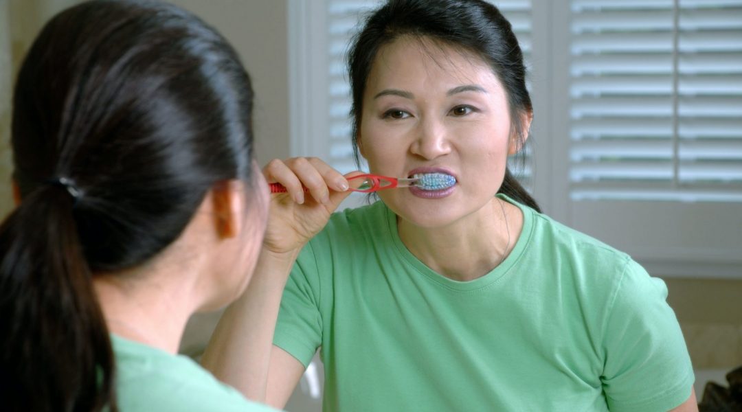 Woman brushing her teeth could be setting herself up for fluoride poisoning.