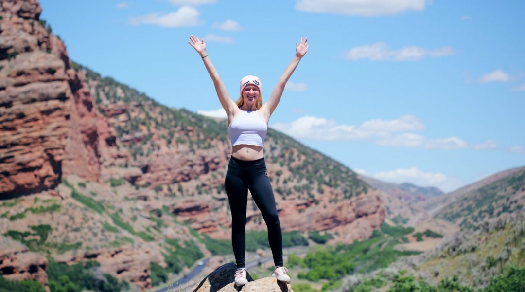 Healthy woman standing on top of a rock in Echo, Utah.