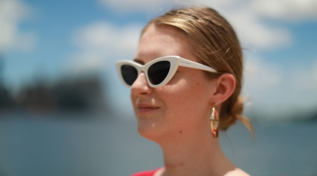 Woman wearing white sunglasses.